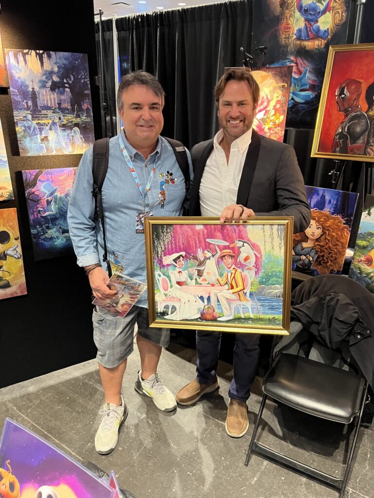 Chris & James C. Mulligan show off a piece of Mulligan's artwork. Photo courtesy of Chris Barry.