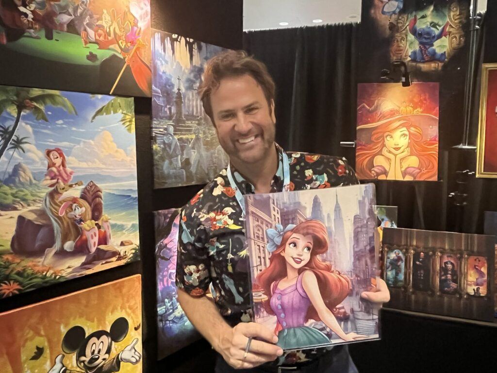 Artist James C. Mulligan show off his NYCC-exclusive Ariel artwork. Photo by Chris Barry.